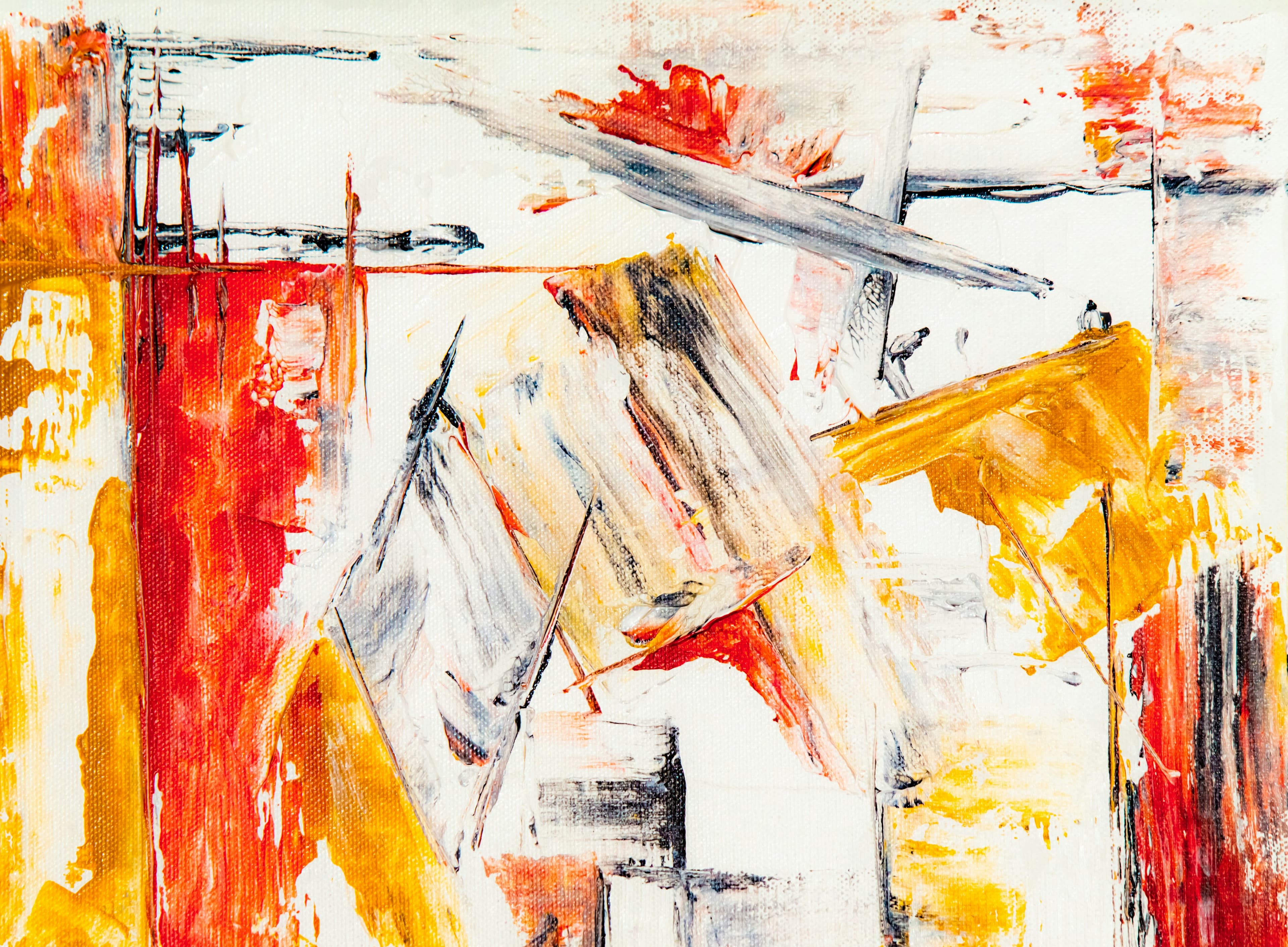 Abstract art with vibrant red and yellow strokes on white canvas